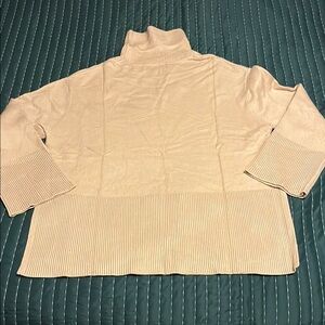 Tan oversized turtleneck sweater.